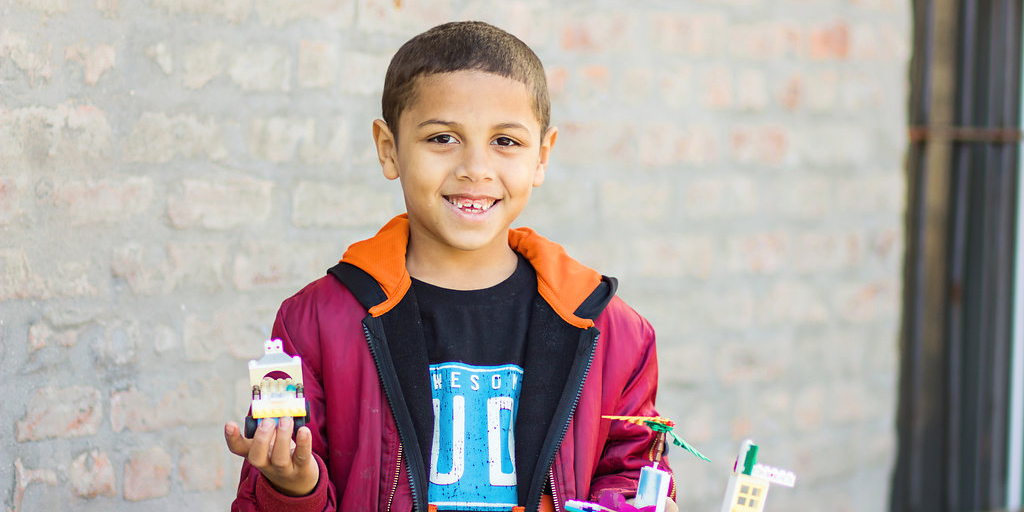 A child holding supplies